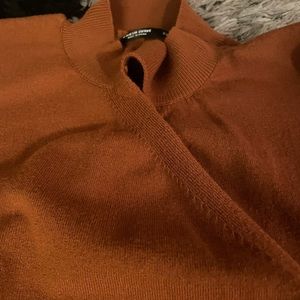 Turtleneck, fabric is open and crosses in front